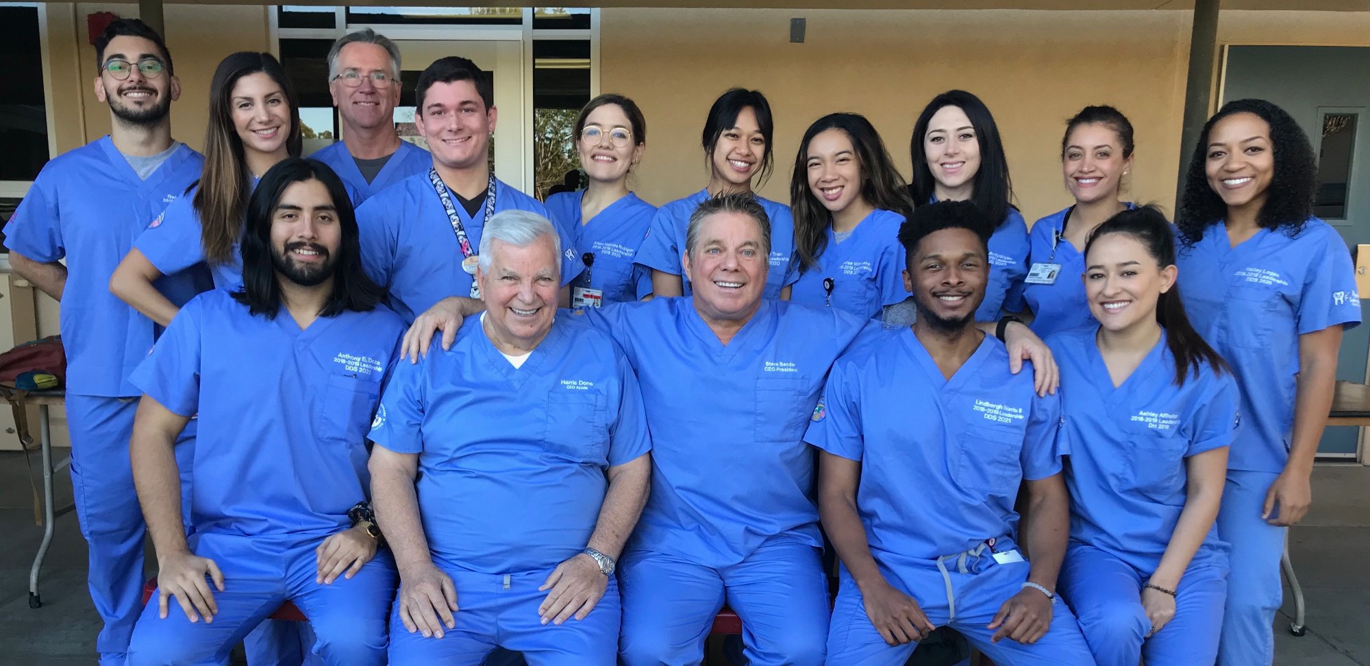 Ayuda volunteers in blue scrubs smiling together