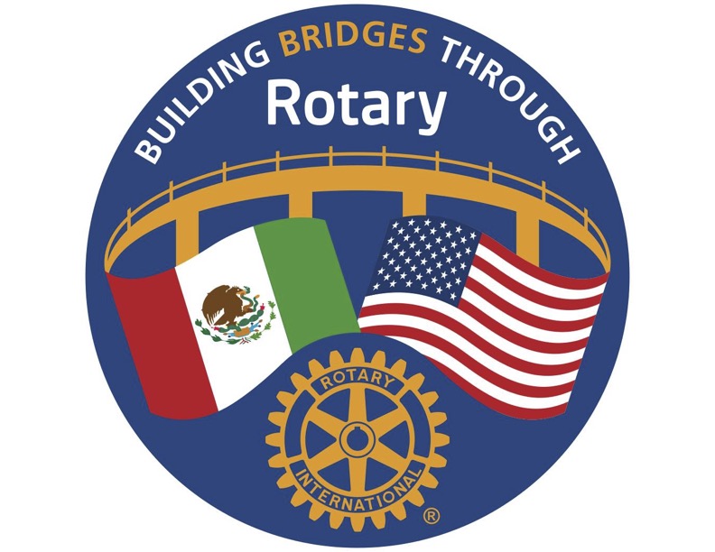 Building Bridges Through Rotary logo: a golden bridge over the flags of Mexico and the United States and the Rotary wheel