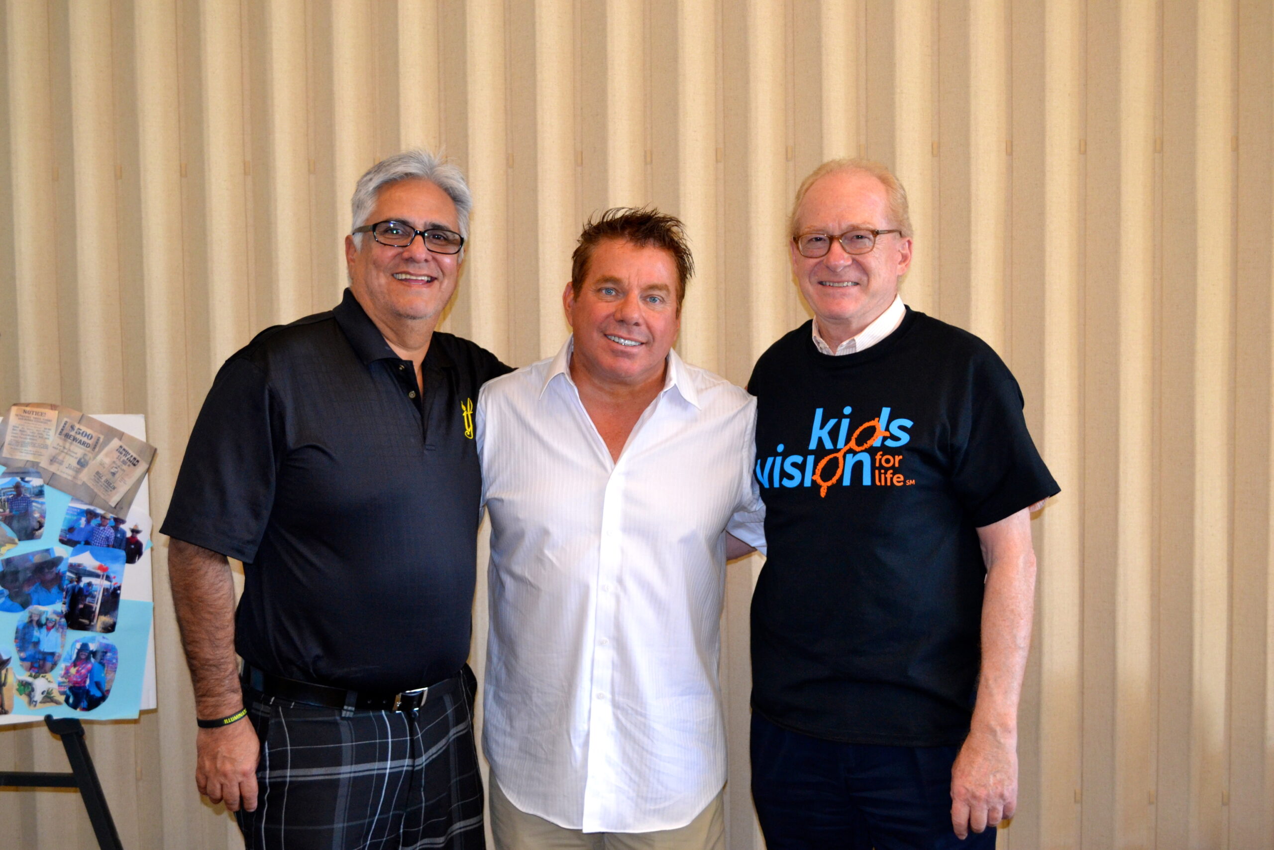 Steve Bender in a white shirt between two friends, with Patrick Esquerre of Kids Vision for Life on the right