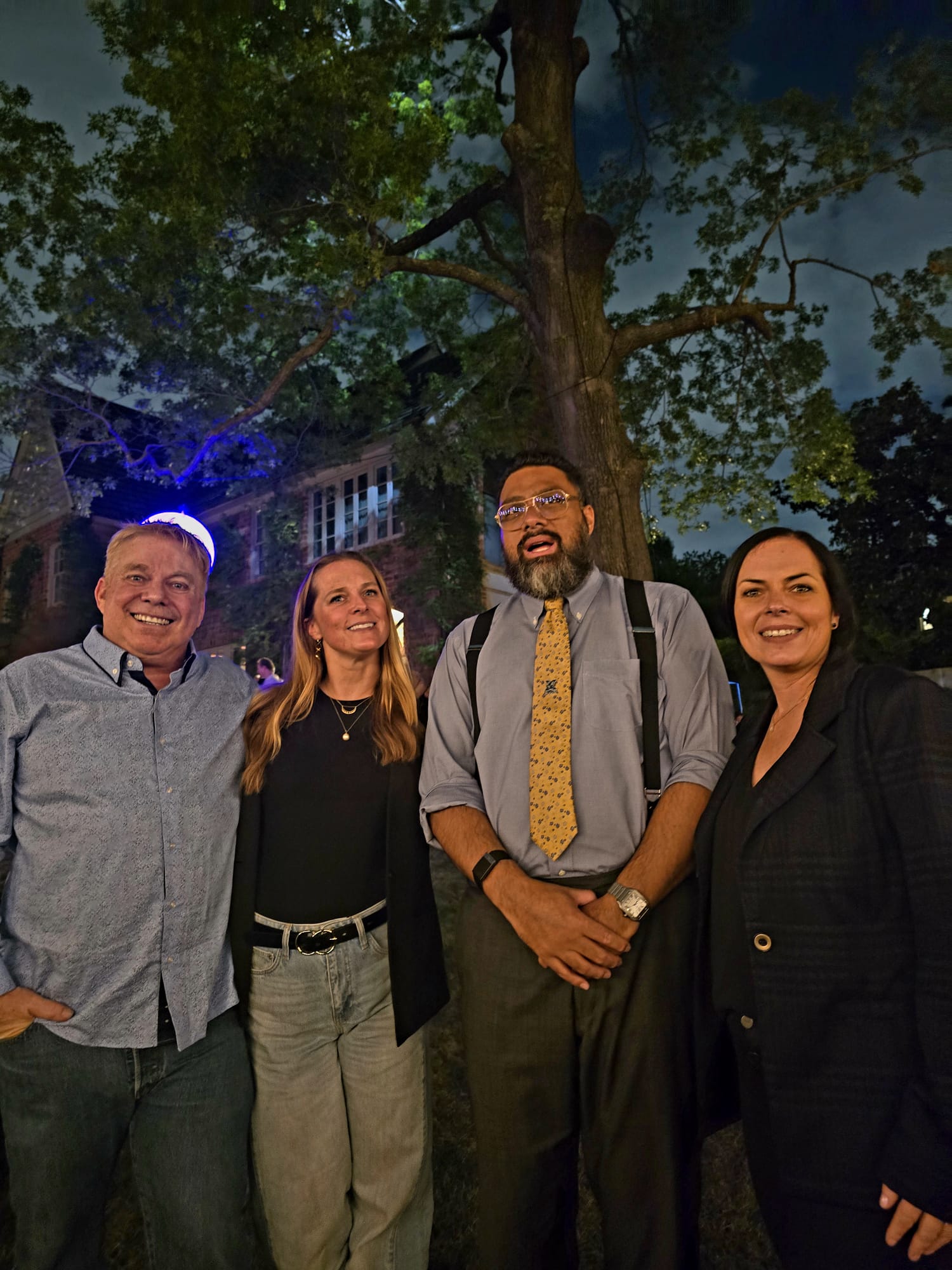 Steve Bender, Natalia Naranjo, the Prime Minister of Tonga and Tracy Stayton outdoors at night under a large tree